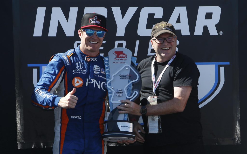 Scott Dixon holding up first place trophy for 2023 Grand Prix of Monterey