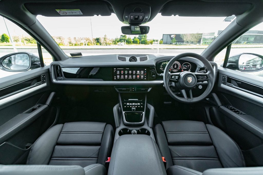Central view of Porsche Cayenne front interior. Dash, screens, centre console