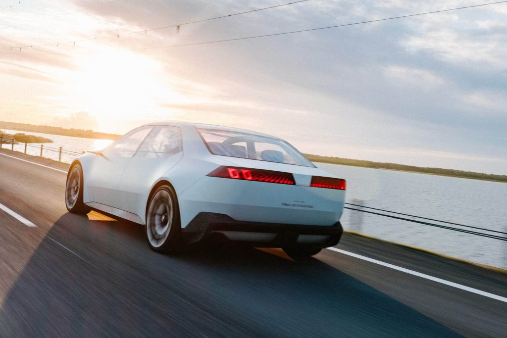 BMW Vision Neue Klasse driving next to lake