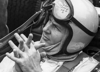 Bruce McLaren sitting in Formula 1 car