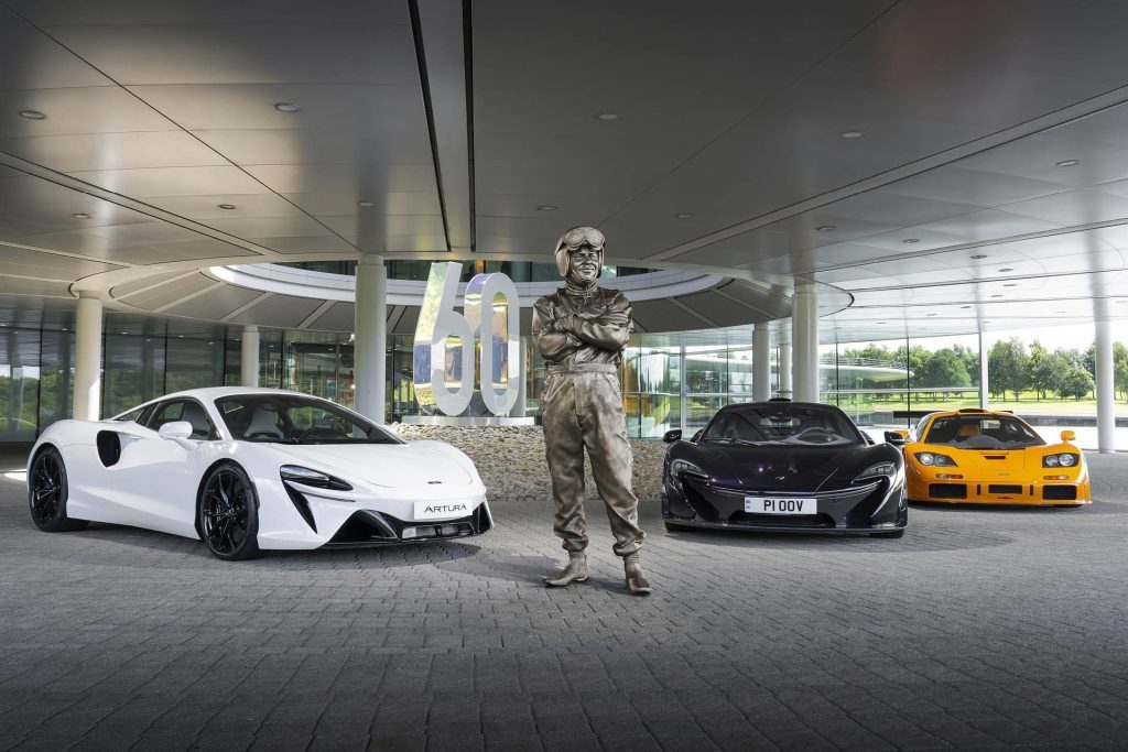 Bruce McLaren statue with supercars