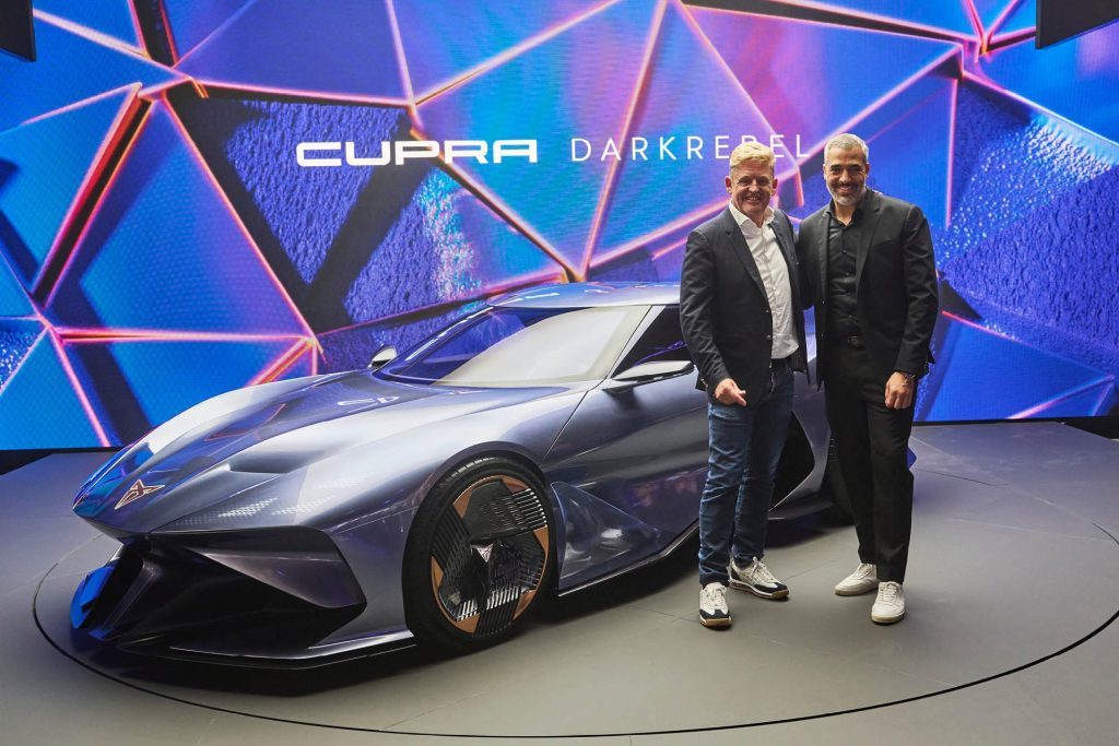 Two men standing next to Cupra DarkRebel
