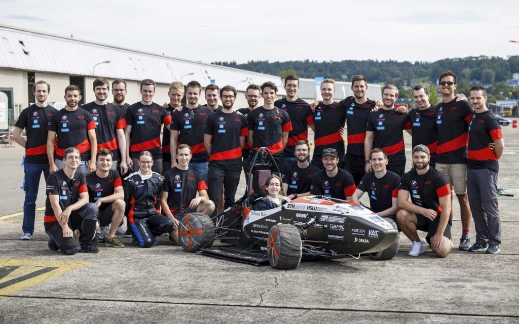 Students standing around Mythen, the world's fastest accelerating EV from 0 to 100km/h