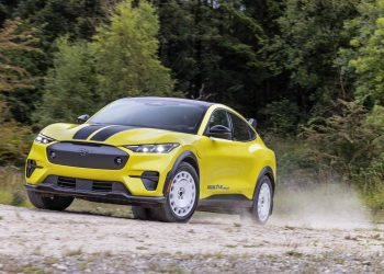 Ford Mustang Mach-E Rally driving on dirt road in forest