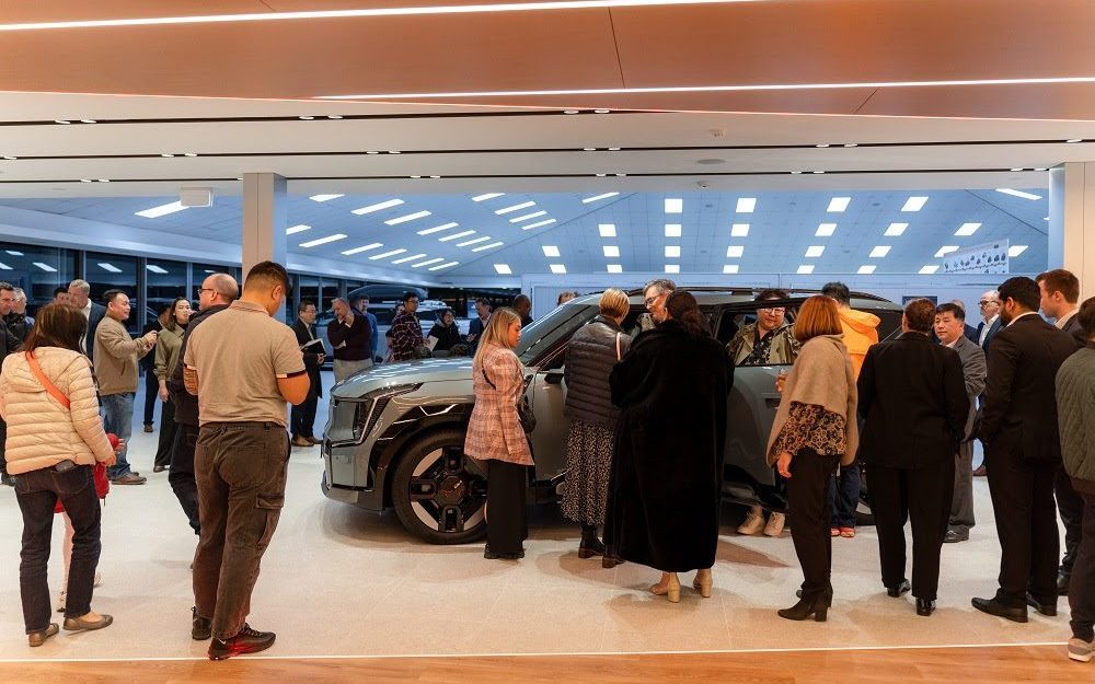 People standing around Kia EV9