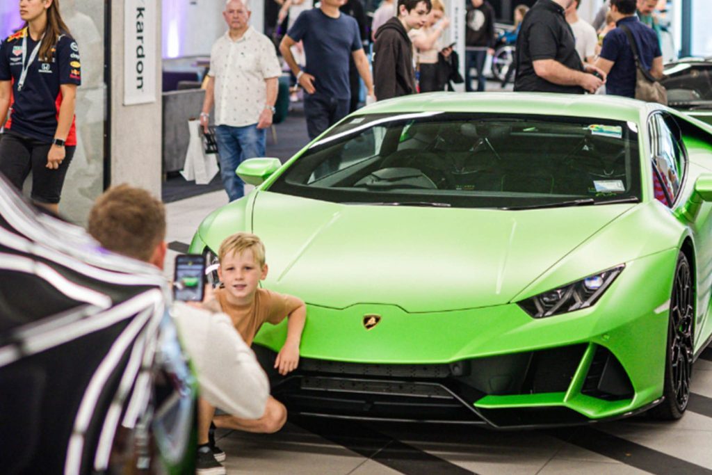 Kid getting photo taken with Lamborghini Huracan