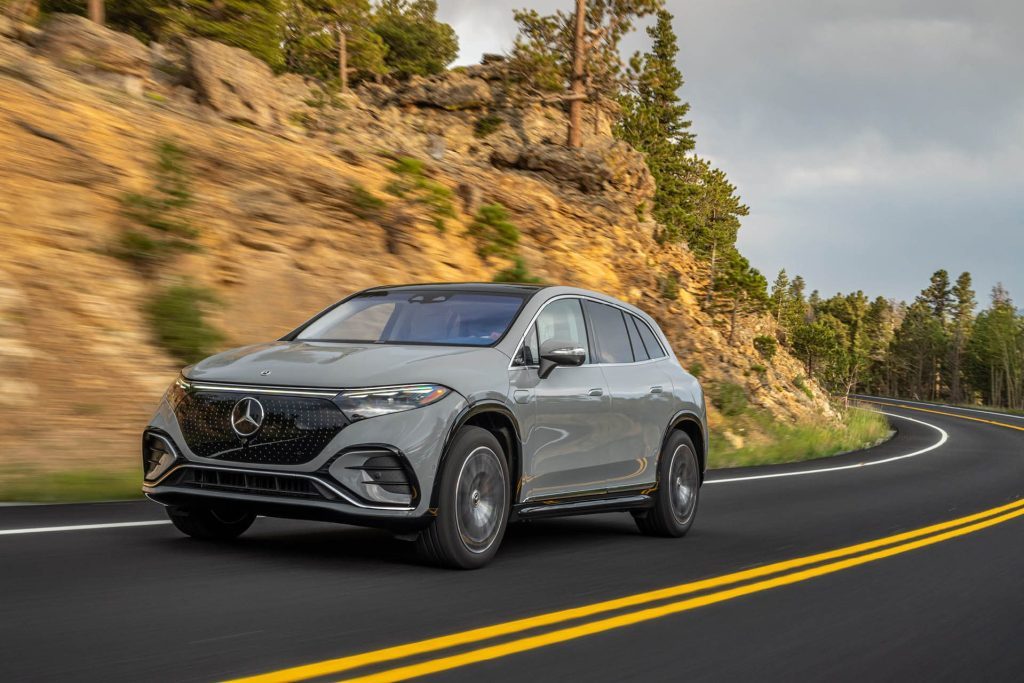 Mercedes-Benz EQS 450 4Matic SUV driving past trees