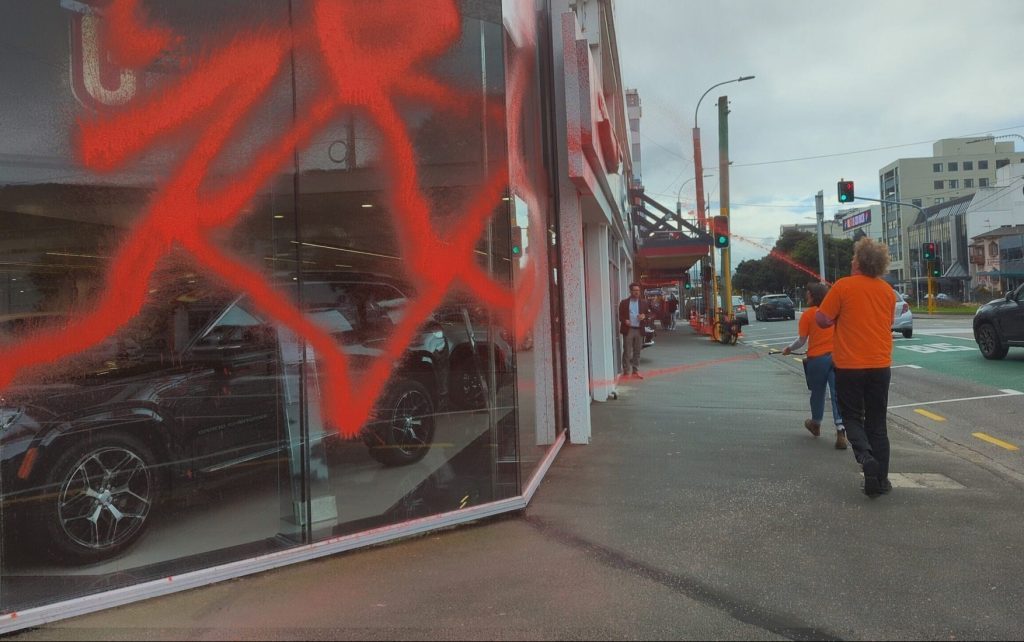 Climate activists vandalising luxury car dealership in Wellington