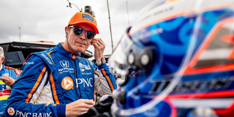 Scott Dixon putting ear pieces in