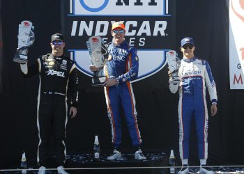 Scott Dixon holding up first place trophy for 2023 Grand Prix of Monterey on podium