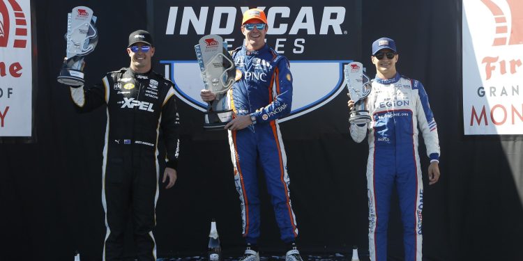 Scott Dixon holding up first place trophy for 2023 Grand Prix of Monterey on podium