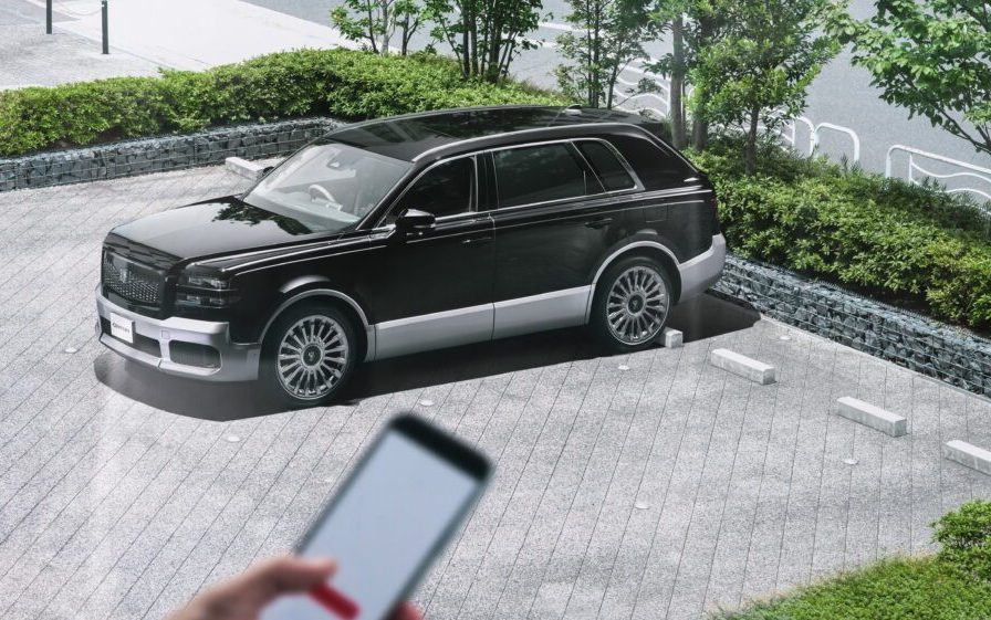 Toyota Century SUV parked by person using phone