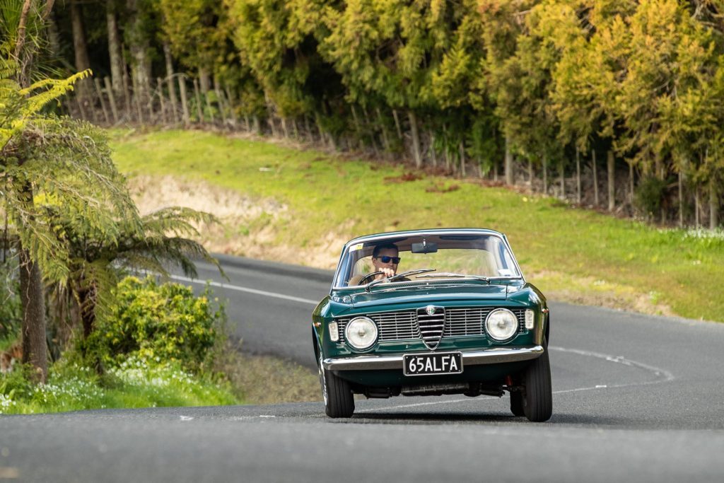 Alfa Romeo Giulia Sprint GT taking a corner, with visible suspension movement