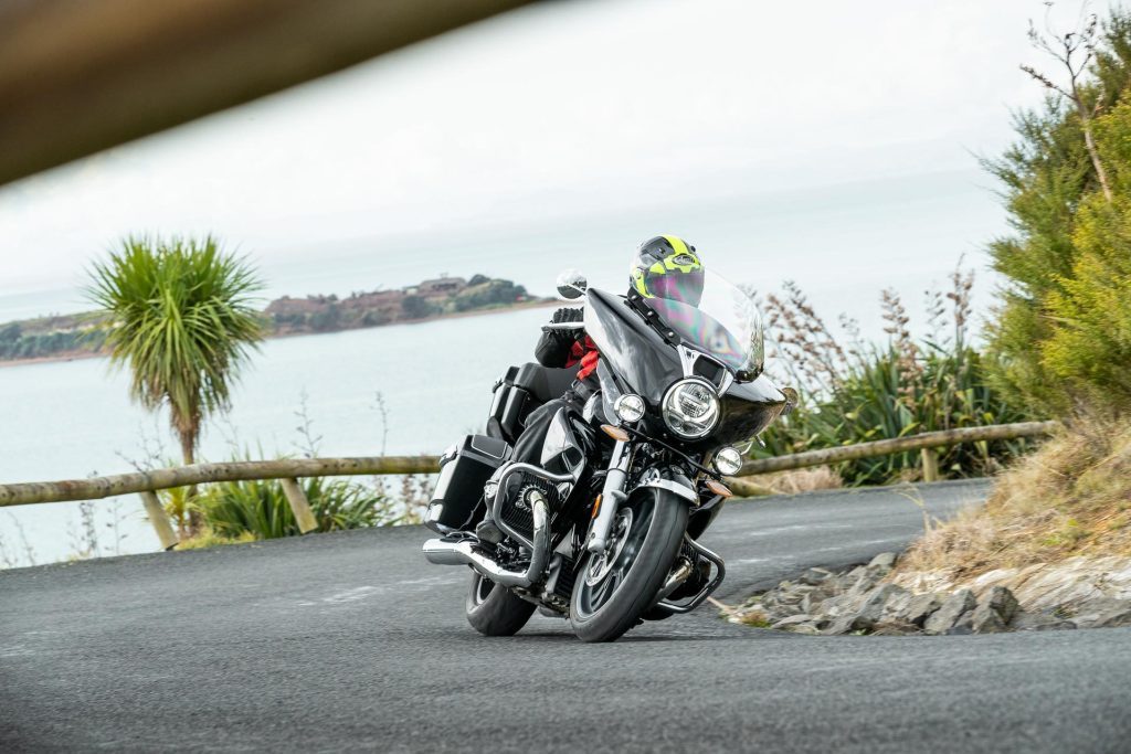 BMW R18 TC, taking a corner with water pictured behind