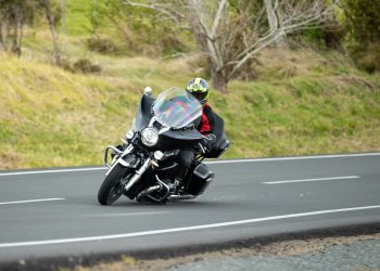 BMW R18 Transcontinental taking a corner, with sparks flying