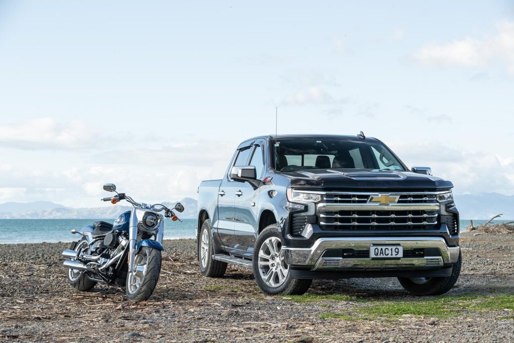 Chevrolet Silverado 1500 LTZ Z71 parked next to American Harley Davidson Fatboy bike