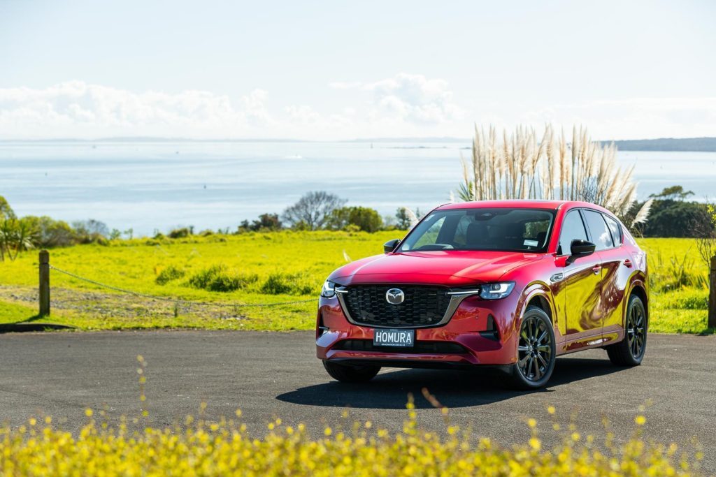 Front quarter of the Mazda CX-60 Homura PHEV with sea behind