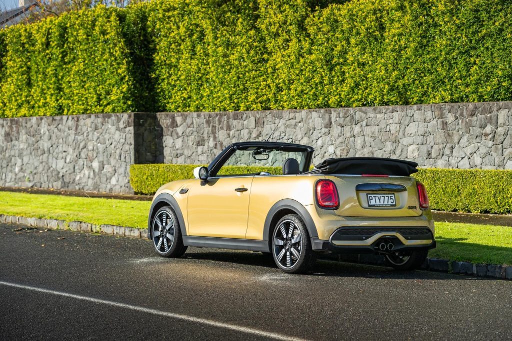 Mini Cooper S convertible, in gold, next to nice wall
