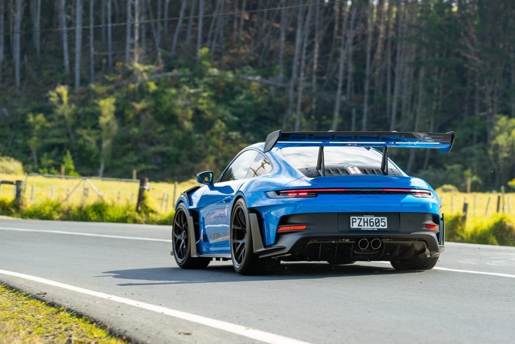 Porsche 911 GT3 RS taking a corner, rear view