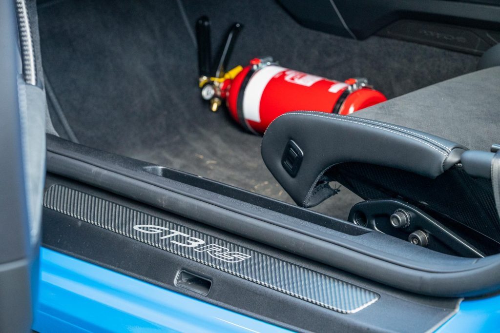 GT3 RS badging on door sill, with fire extinguisher pictured behind