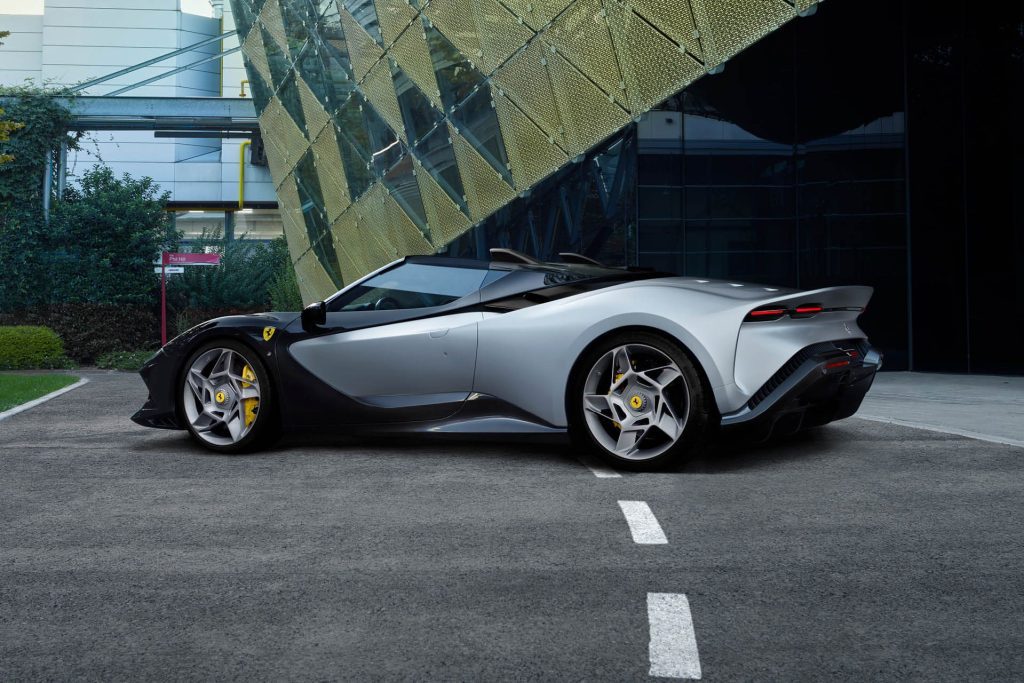 Ferrari SP-8 parked on road next to building