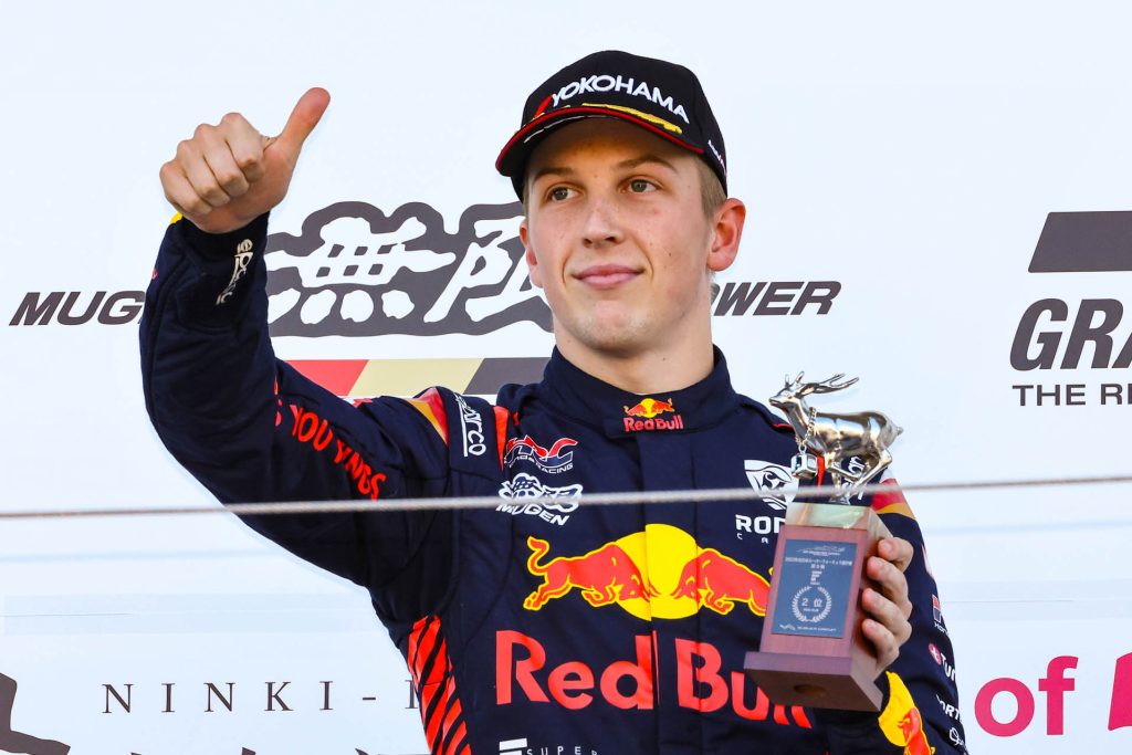 Liam Lawson giving thumbs up on Super Formula podium at Suzuka