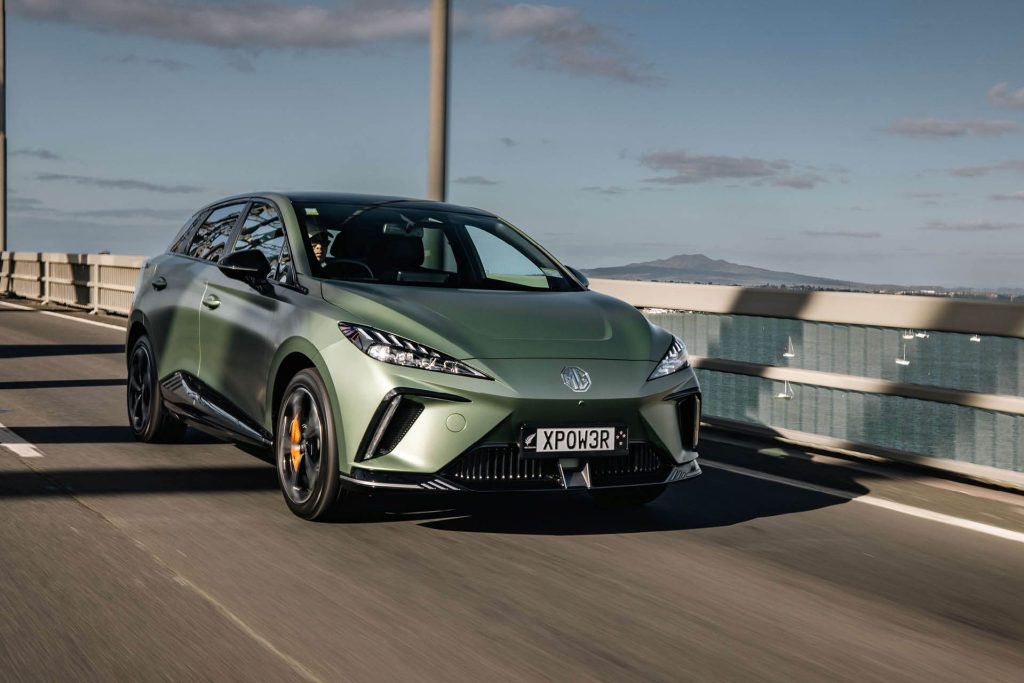 MG4 XPower driving over Harbour Bridge with Rangitoto in background