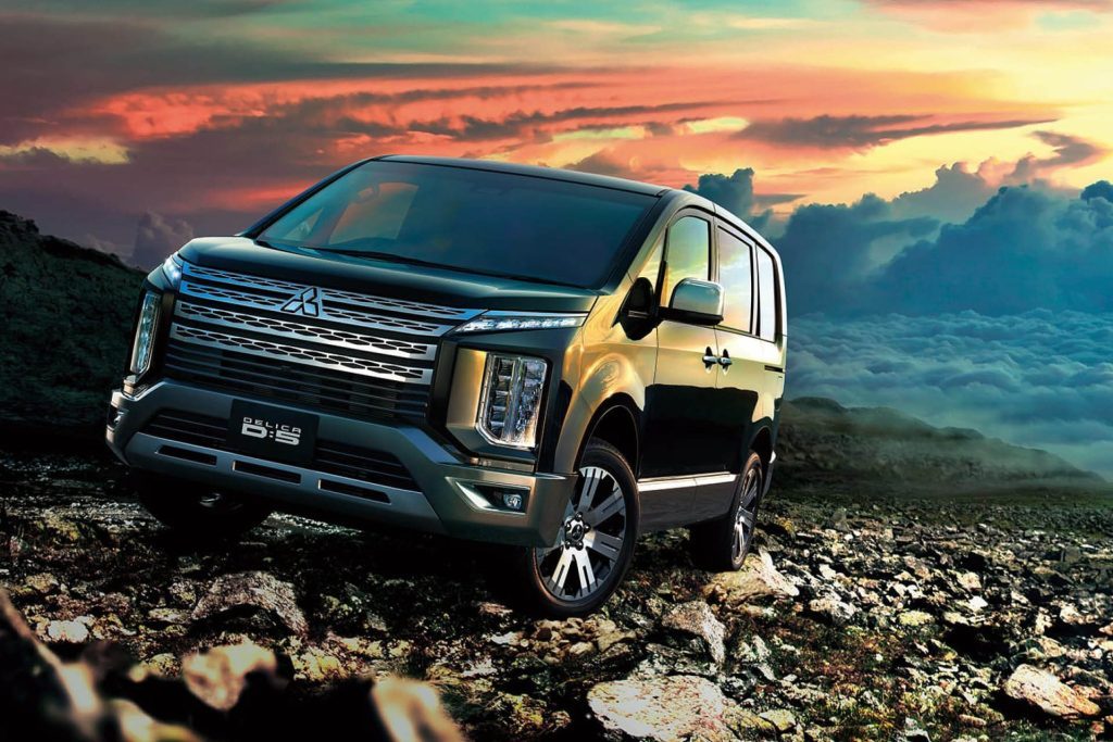 Mitsubishi Delica D:5 parked on rocks at sunset 