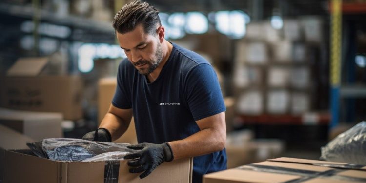 Man putting car parts in box