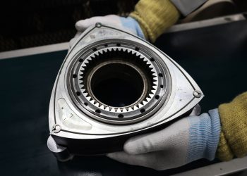 Person holding Mazda rotary engine rotor