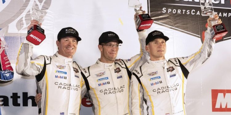Scott Dixon and Petit Le Mans teammates holding up throphies