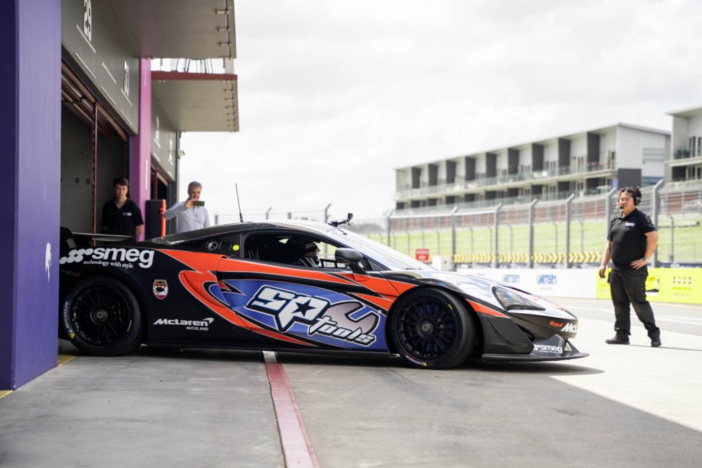 SP Tools McLaren 570S GT4 pulling out of pit lane garage at Hampton Downs