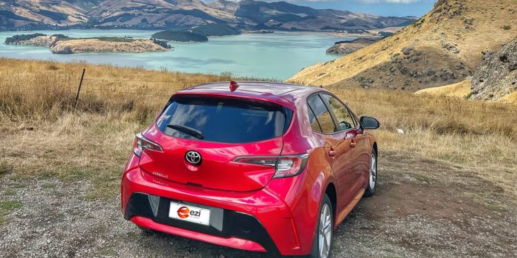 Toyota Corolla Ezi rental car parked by lake look out