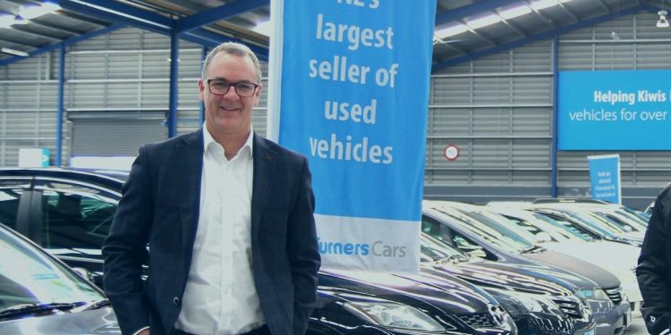 Turners CEO Todd Hunter standing with cars