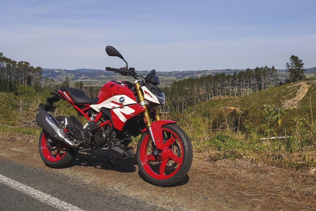 BMW G 310 R in red, parked on the side of the road