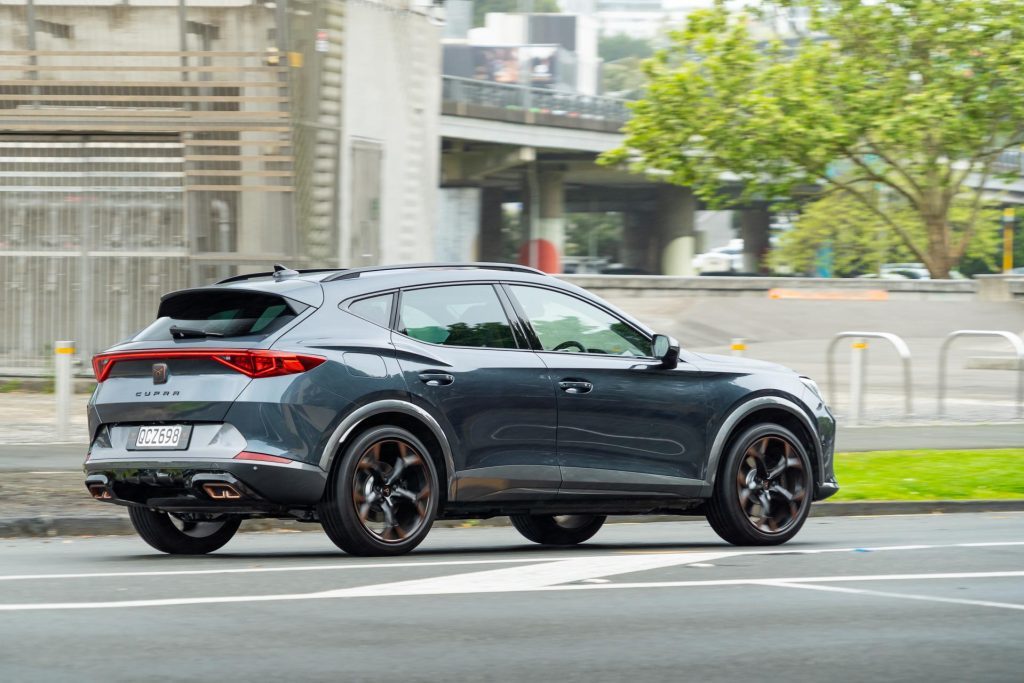 Rear view of the Cupra Formentor V e-Hybrid, driving in urban environment