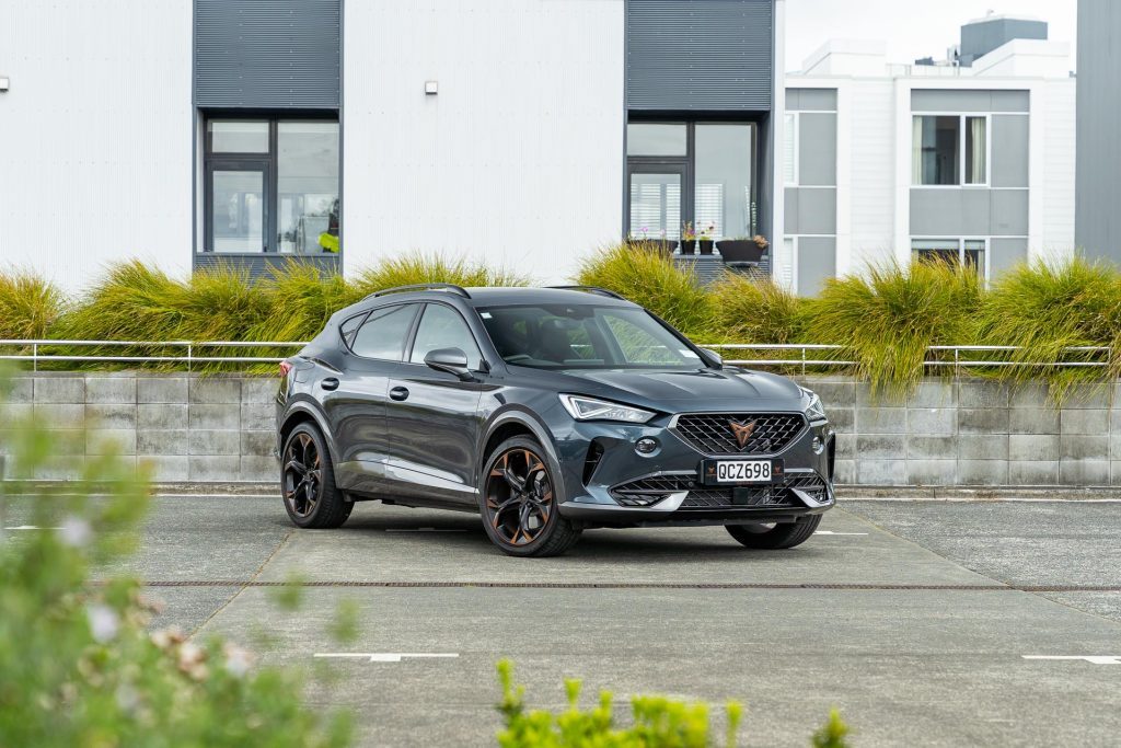 Cupra Formentor V e-Hybrid quarter shot, from behind bushes