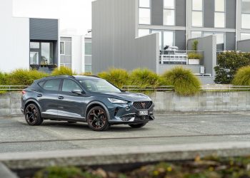 Cupra FOrmentor V e-Hybrid parked near apartments