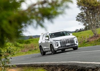 white Hyundai Palisade action shot, taking a corner