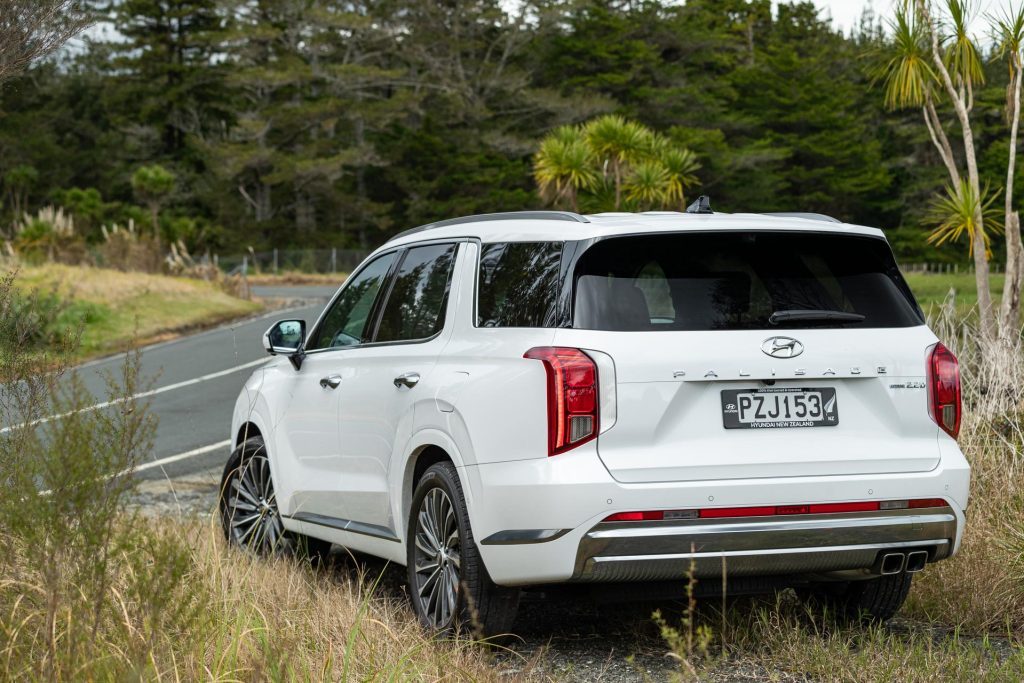 Hyundai Palisade shown from the rear, parked off road