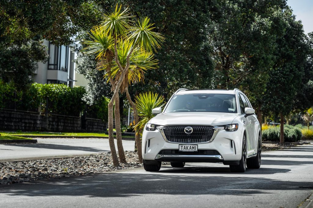 Mazda CX-90 Takami driving in a suburban neighbourhood