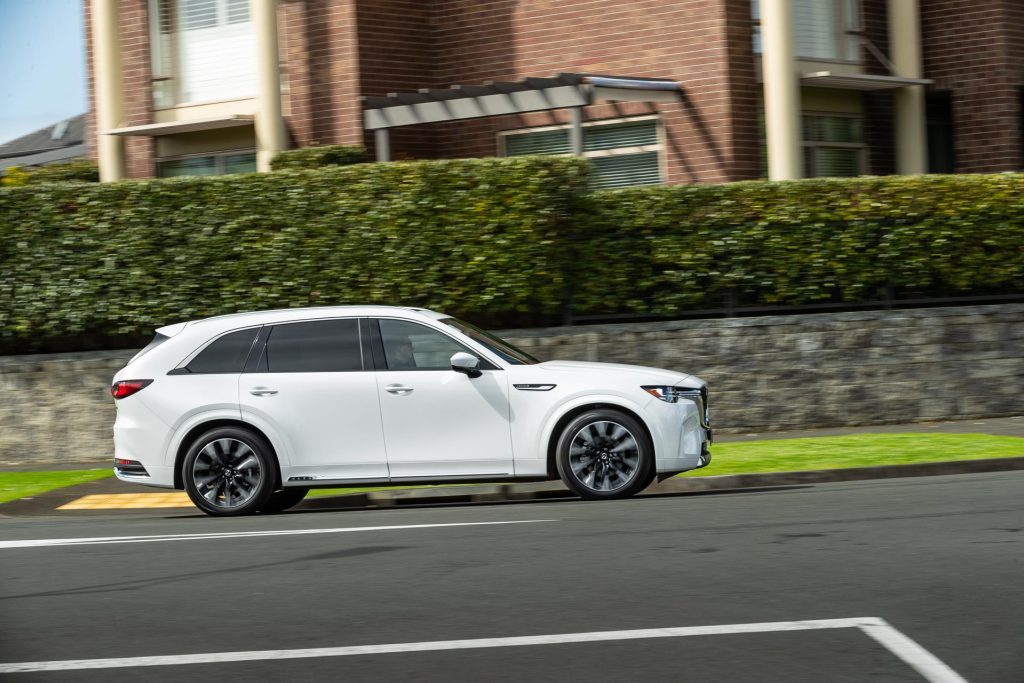 Side profile panning shot of the Mazda CX-90 Takami