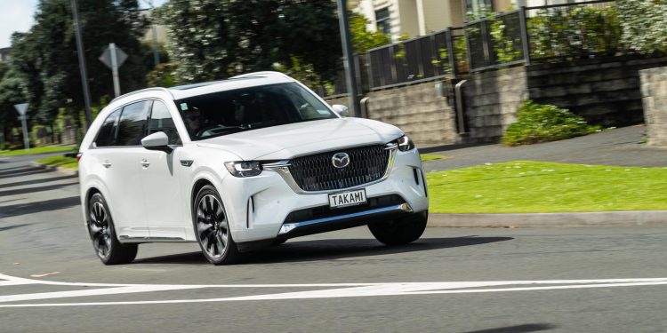 Mazda CX-90 taking a corner in white