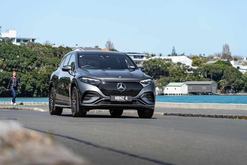 Mercedes-Benz EQS 450 4Matic driving along the waterfront
