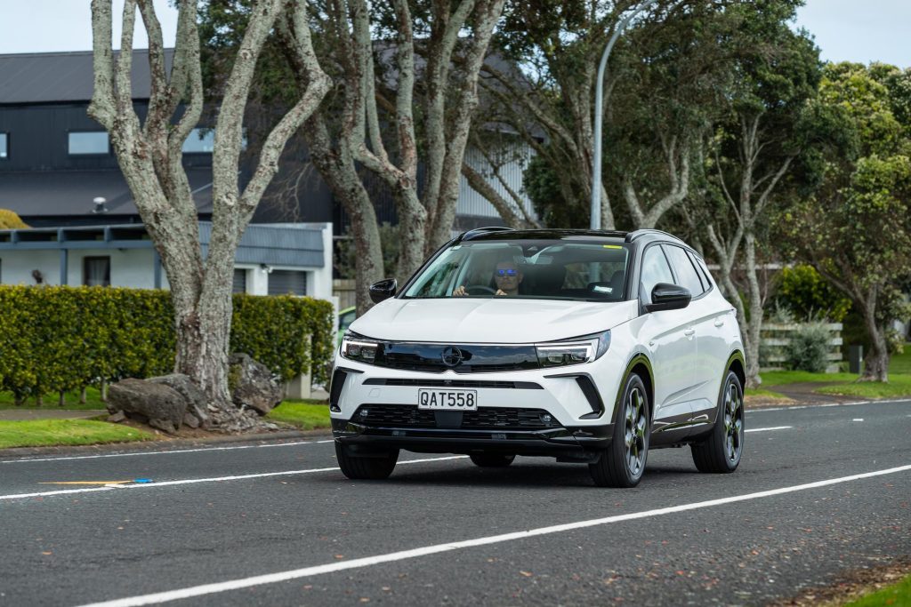 Opel Grandland Hybrid SRi driving on road, shown from front