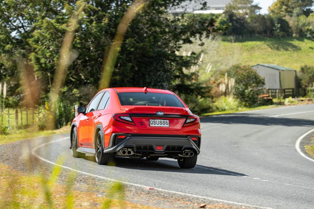 Rear view of Subaru WRX AKA taking a corner at pace