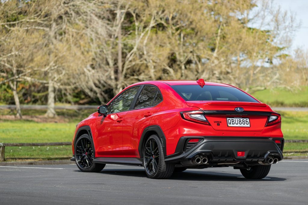 Subaru WRX AKA in red, rear quarter shot parked in carpark