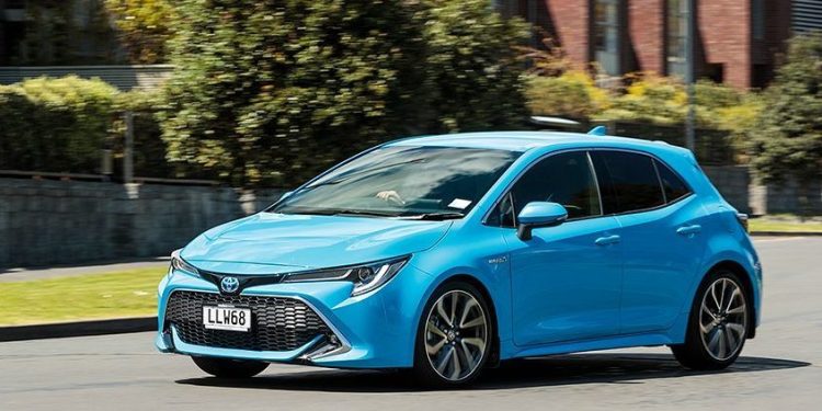 Toyota Corolla Hybrid ZR driving through residential area