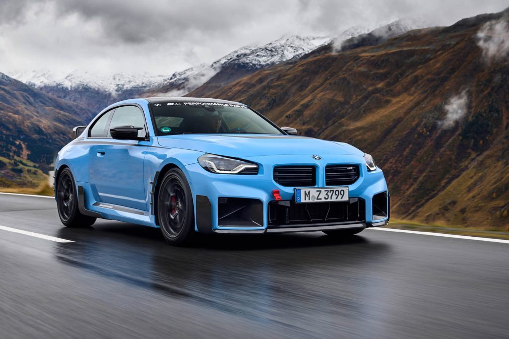 BMW M2 with centrelock wheels and carbon fibre add ons driving through mountain pass