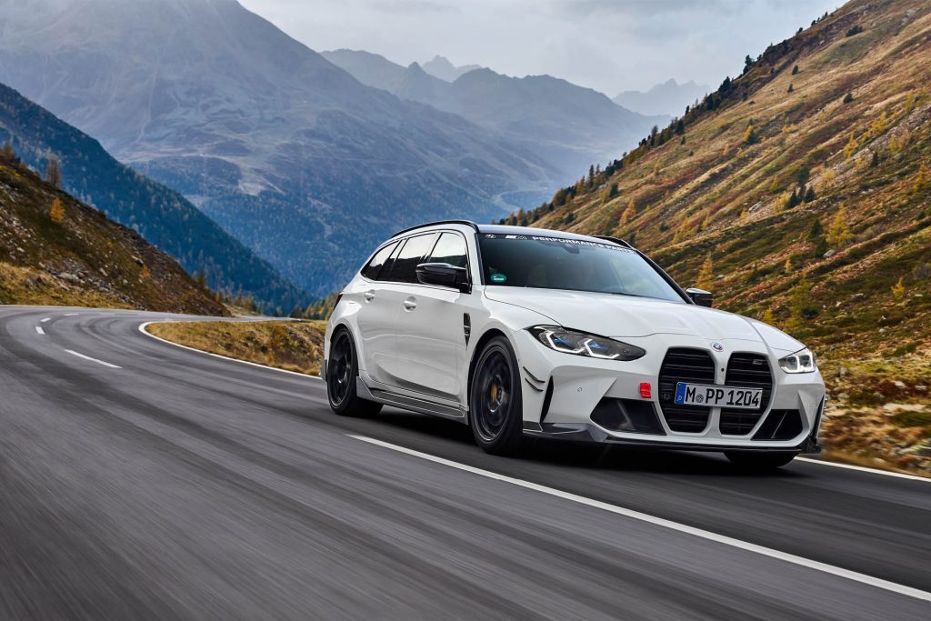 BMW M3 Touring with centrelock wheels and carbon fibre add ons driving through mountain pass